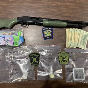 Opiates, cocaine, cash and this shotgun were seized during a raid on an alleged drug dealer's home Jan. 4. (CCSO)