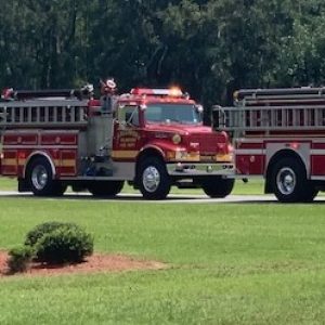 Fire trucks line up at People's Funeral Home after escorting Billy Six Monday.