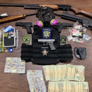 Firearms, drugs, cash and body armor were confiscated in the raid. (CCSO photo)