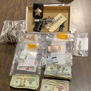 Drugs, cash and a .380 handgun were confiscated after an early morning raid near Chadbourn. (CCSO Photo)